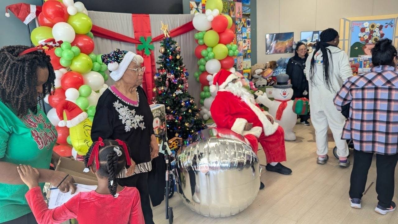 Volunteers and families celebrating at a community holiday event
