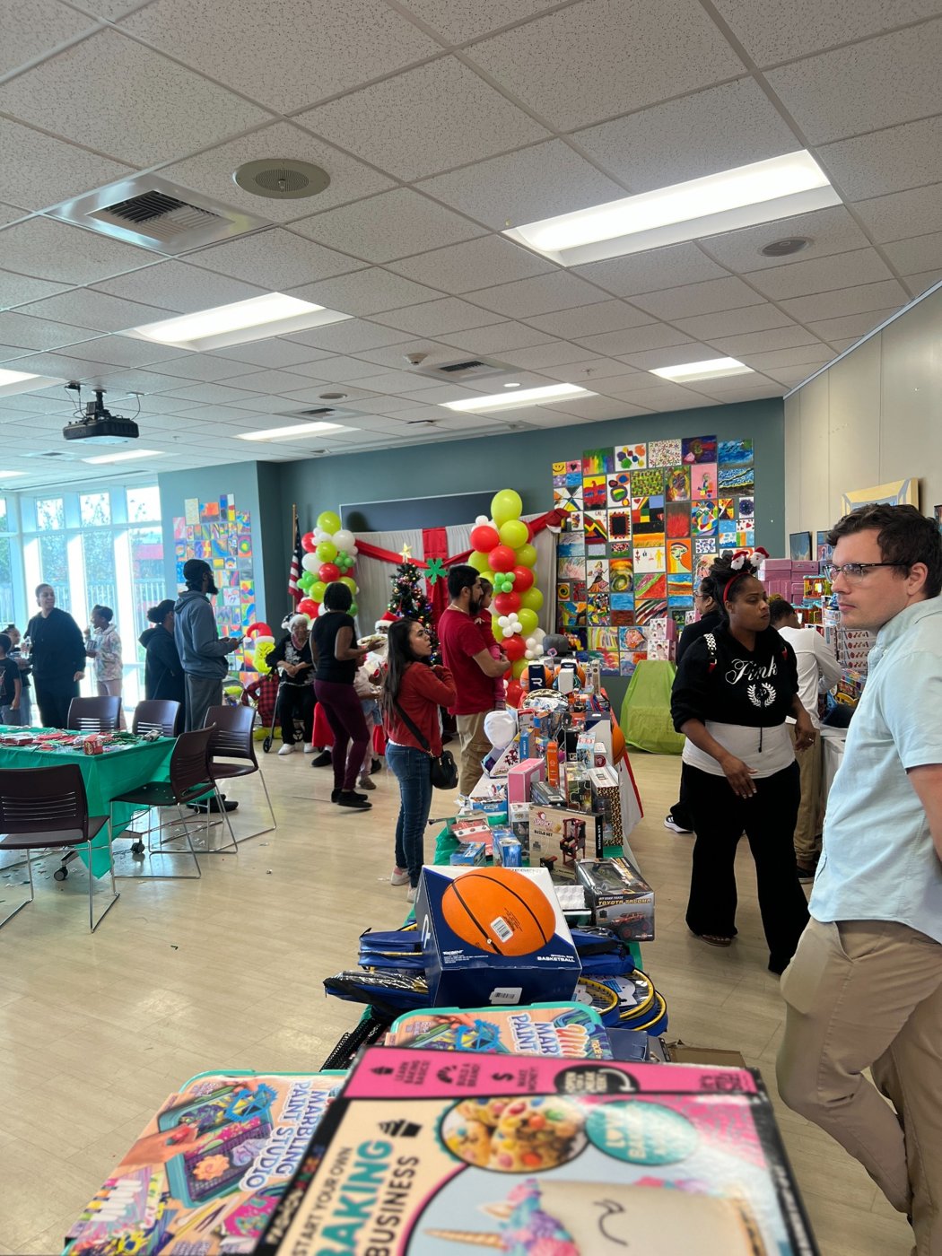 Tables and volunteers at a community holiday event